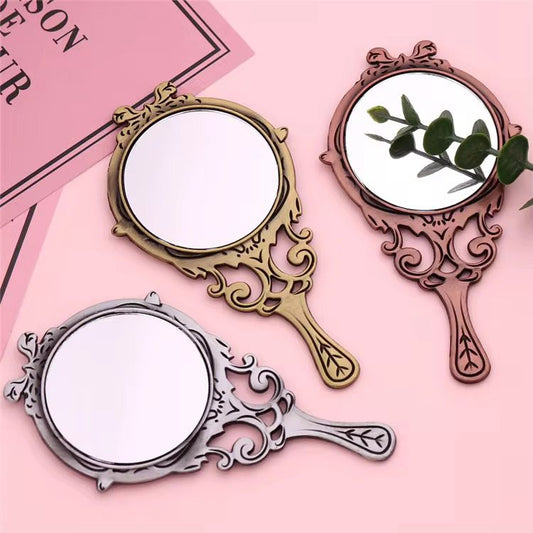 small metal antique hand mirror