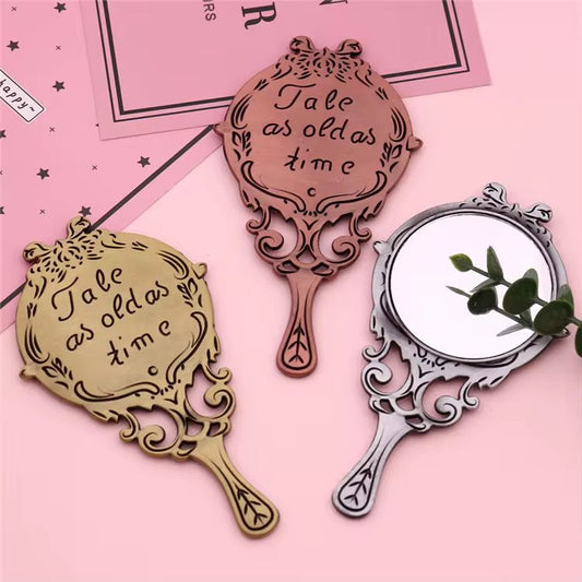 small metal antique hand mirror